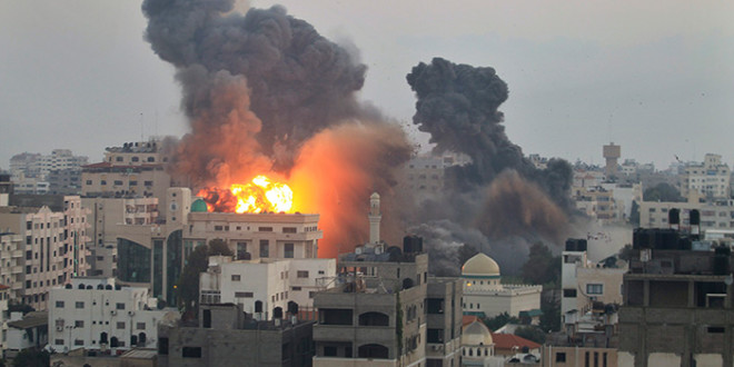 Smoke and fire from an Israeli bomb rises into the air ove Gaza City