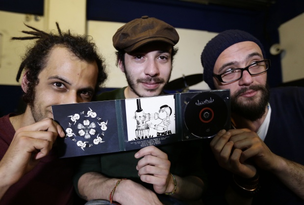 Lead singer and bass guitarist Khaled Omran, electric guitarist Tarek Khuluki, and drummer Dani Shukri of Syrian band, Tanjaret Daghet (AFP)