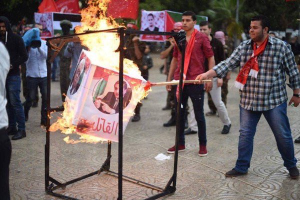 Attivisti del Fplp bruciano poster con le immagini di Abu Mazen e altri dirigenti dell'Anp (foto da twitter)